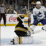 
              Boston Bruins goaltender Linus Ullmark, front left, makes a save off his shoulder as Vancouver Canucks' Brock Boeser looks for a rebound during the third period of an NHL hockey game Sunday, Nov. 13, 2022, in Boston. (AP Photo/Winslow Townson)
            