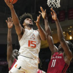 
              Miami's forward Norchad Omier (15) drives to the basket over Rutgers' center Clifford Omoruyi (11) during the first half of an NCAA college basketball game, Wednesday, Nov. 30, 2022, in Coral Gables, Fla. (AP Photo/Marta Lavandier)
            