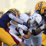 
              Stanford running back Mitch Leigber, middle, runs the ball against California during the first half of an NCAA college football game in Berkeley, Calif., Saturday, Nov. 19, 2022. (AP Photo/Godofredo A. Vásquez)
            