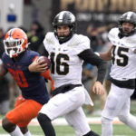 
              Purdue quarterback Aidan O'Connell carries the ball during the first half of an NCAA college football game against Illinois Saturday, Nov. 12, 2022, in Champaign, Ill. (AP Photo/Charles Rex Arbogast)
            