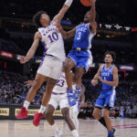 
              Duke guard Jeremy Roach (3) drives to the basket against Kansas forward Jalen Wilson (10) during the first half of an NCAA college basketball game, Tuesday, Nov. 15, 2022, in Indianapolis. (AP Photo/Darron Cummings)
            