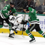 
              Dallas Stars left wing Jamie Benn, left, and center Wyatt Johnston, right, work the puck around Los Angeles Kings center Blake Lizotte, center, during the first period of an NHL hockey game Tuesday, Nov. 1, 2022, in Dallas. (AP Photo/Ray Carlin)
            