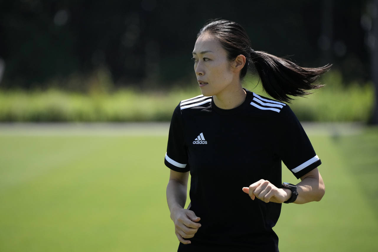FILE - Japanese referee Yoshimi Yamashita warms up during a training session Monday, June 27, 2022,...