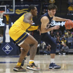
              Penn forward Nick Spinoso, right, is defended by West Virginia forward Jimmy Bell Jr., left, during the first half of an NCAA college basketball game in Morgantown, W.Va., Friday, Nov. 18, 2022. (AP Photo/Kathleen Batten)
            