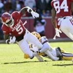 
              Arkansas running back Raheim Sanders (5) is tackled by LSU safety Joe Foucha (13) during the first half of an NCAA college football game Saturday, Nov. 12, 2022, in Fayetteville, Ark. (AP Photo/Michael Woods)
            