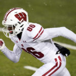 
              FILE - Wisconsin wide receiver Devin Chandler runs up field during an NCAA college football game against Iowa, on Dec. 12, 2020, in Iowa City, Iowa. Chandler, who transferred to the University of Virginia, was one of three Virginia football players killed in a shooting, Sunday, Nov. 13, 2022, in Charlottesville, Va., while returning from a class trip to see a play. (AP Photo/Charlie Neibergall, File)
            