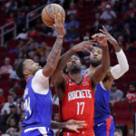 
              Los Angeles Clippers forward Norman Powell (24) strips the ball away from Houston Rockets forward Tari Eason (17) with an assist from Clippers guard Paul George, right, during the first half of an NBA basketball game Wednesday, Nov. 2, 2022, in Houston. (AP Photo/Michael Wyke)
            