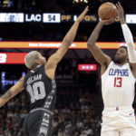 
              Los Angeles Clippers guard Paul George (13) shoots over San Antonio Spurs forward Jeremy Sochan (10) during the second half of an NBA basketball game Friday, Nov. 4, 2022, in San Antonio. (AP Photo/Nick Wagner)
            