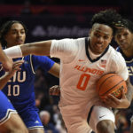 
              Illinois' Terrence Shannon Jr. (0) works the ball inside against Eastern Illinois' Sincere Malone (5), Kinyon Hodges (10) and Rodolfo Bolis during the first half of an NCAA college basketball game Monday, Nov. 7, 2022, in Champaign, Ill. (AP Photo/Michael Allio)
            