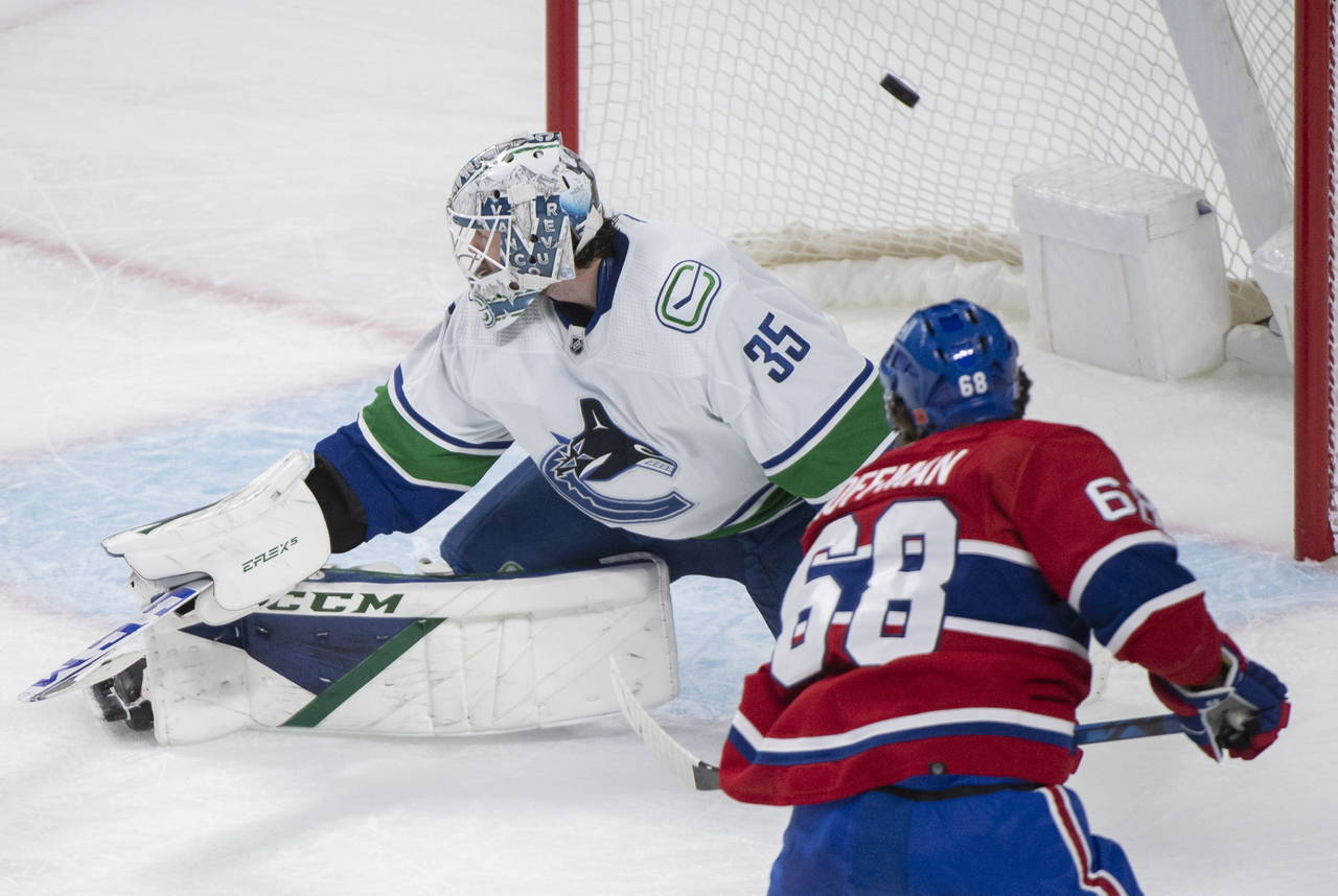 Montreal Canadiens' Mike Hoffman (68) scores past Vancouver Canucks goaltender Thatcher Demko durin...