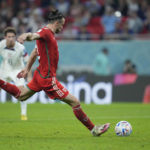 
              Wales' Gareth Bale shoots a penalty kick to score during the World Cup, group B soccer match between the United States and Wales, at the Ahmad Bin Ali Stadium in Doha, Qatar, Monday, Nov. 21, 2022. (AP Photo/Ashley Landis)
            