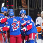 
              New York Rangers' Filip Chytil (72) celebrates with teammates after scoring a goal as New York Islanders' Adam Pelech (3) skates past them during the first period of an NHL hockey game Tuesday, Nov. 8, 2022, in New York. (AP Photo/Frank Franklin II)
            
