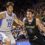 
              Delaware's Gianmarco Arletti (4) handles the ball as Duke's Ryan Young (15) defends during the first half of an NCAA college basketball game in Durham, N.C., Friday, Nov. 18, 2022. (AP Photo/Ben McKeown)
            