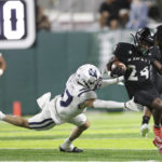 
              Hawaii running back Tylan Hines (24) slips past Utah State safety Luke Marion (17) for a 69-yard touchdown during the fourth quarter of an NCAA college football game, Saturday, Nov. 12, 2022, in Honolulu. (AP Photo/Marco Garcia)
            