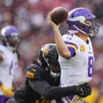 
              Minnesota Vikings quarterback Kirk Cousins (8) throws a pass while under pressure from Washington Commanders defensive end James Smith-Williams (96) during the second half of an NFL football game, Sunday, Nov. 6, 2022, in Landover, Md. (AP Photo/Julio Cortez)
            