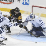 
              Pittsburgh Penguins left wing Jason Zucker is slowed down by Toronto Maple Leafs defenseman Victor Mete (98) and right wing William Nylander as he shoots on goalie Erik Kallgren during the first period of a hockey game, Saturday, Nov. 26, 2022, in Pittsburgh. (AP Photo/Philip G. Pavely)
            