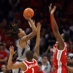 
              Robert Morris forward Kahliel Spear, left, goes up to shoot in front of Ohio State guard Roddy Gayle, center, and center Felix Okpara during the first half of an NCAA college basketball game in Columbus, Ohio, Monday, Nov. 7, 2022. (AP Photo/Paul Vernon)
            