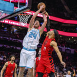 
              Charlotte Hornets center Mason Plumlee (24) is fouled by Portland Trail Blazers guard Josh Hart (11) during the first half of an NBA basketball game Wednesday, Nov. 9, 2022, in Charlotte, N.C. (AP Photo/Scott Kinser)
            
