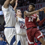 
              Alabama forward Brandon Miller (24) works against South Alabama center Kevin Samuel (21) and guard Owen White (22) during the first half of an NCAA college basketball game Tuesday, Nov. 15, 2022, in Mobile, Ala. (AP Photo/Vasha Hunt)
            