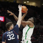 
              Oregon center N'Faly Dante, right, shoots over Connecticut center Donovan Clingan during the second half of an NCAA college basketball game in the Phil Knight Invitational tournament in Portland, Ore., Thursday, Nov. 24, 2022. (AP Photo/Craig Mitchelldyer)
            