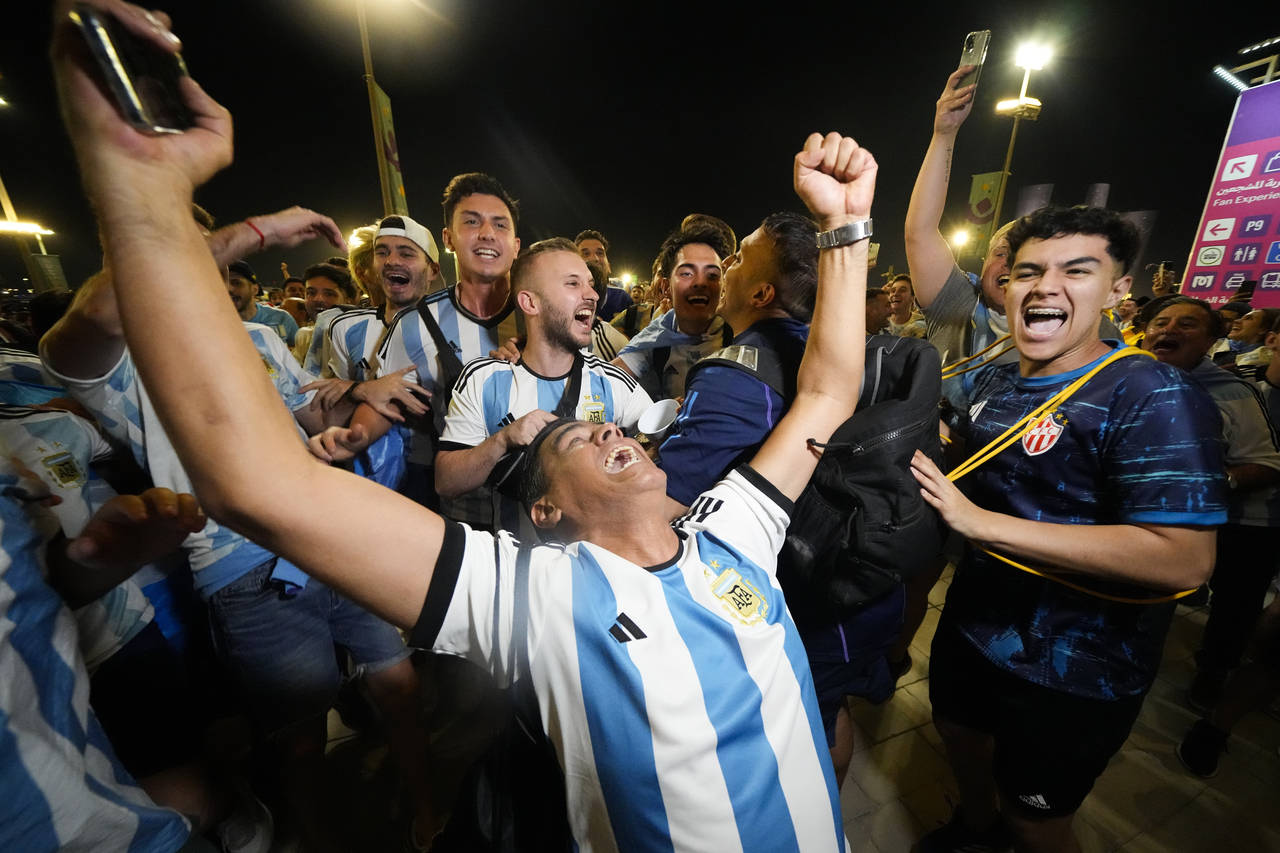 Supporters from Argentina celebrate outside Lusail Stadium following their team's 2-0 victory over ...