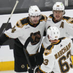 
              Boston Bruins left wing Jake DeBrusk (74) is congratulated by Brad Marchand (63) and David Pastrnak (88) after his goal against the St. Louis Blues during the first period of an NHL hockey game Monday, Nov. 7, 2022, in Boston. (AP Photo/Charles Krupa)
            