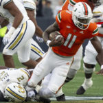 
              Miami quarterback Jacurri Brown (11) is tackled by Georgia Tech's linebacker Ayinde Eley (2) in the first half of an NCAA college football game Saturday, Nov. 12, 2022, in Atlanta. (AP Photo/Hakim Wright Sr.)
            