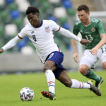 
              FILE - United States's Yunus Musah, left, duels for the ball with Northern Ireland's Corry Evans during an international friendly soccer match between Northern Ireland and United States, at Windsor Park, Belfast, Northern Ireland, on March 28, 2021. (AP Photo/Peter Morrison, File)
            