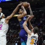 
              Charlotte Hornets guard James Bouknight (2) drives to the basket as Miami Heat guards Gabe Vincent (2) and Duncan Robinson (55) defend during the first half of an NBA basketball game Thursday, Nov. 10, 2022, in Miami. (AP Photo/Marta Lavandier)
            
