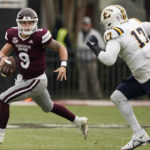
              Mississippi State quarterback Chance Lovertich (9) evades a tackle attempt by East Tennessee State defensive lineman Rodney Wright (17) during the second half of an NCAA college football game in Starkville, Miss., Saturday, Nov.19, 2022. Mississippi State won 56-7. (AP Photo/Rogelio V. Solis)
            