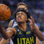 
              Utah Jazz point guard Collin Sexton, front, drives to the basket during the first half of an NBA basketball game against the Dallas Mavericks, Wednesday, Nov. 2, 2022, in Dallas. (AP Photo/Gareth Patterson)
            