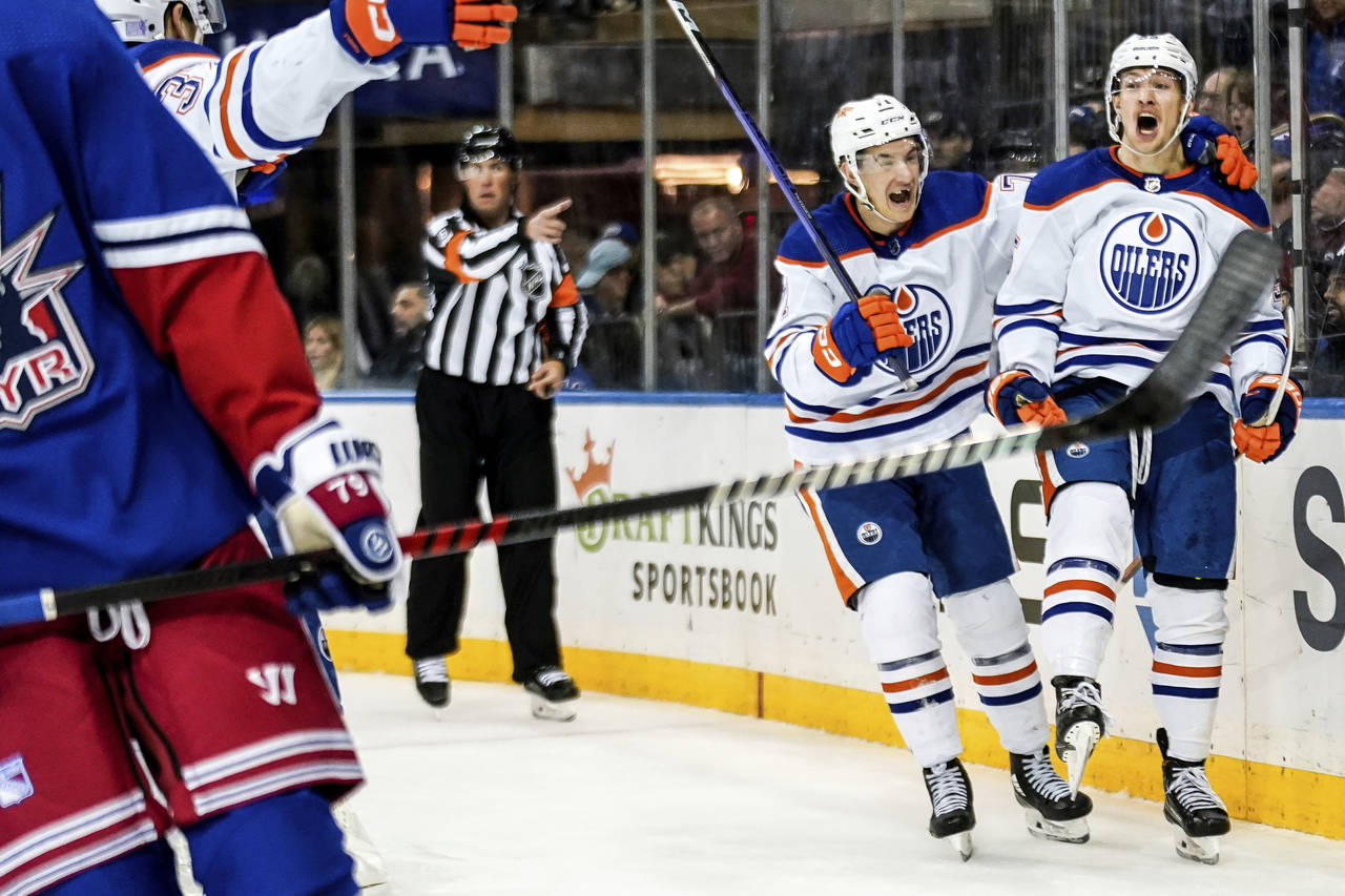 Edmonton Oilers center Ryan McLeod (71) and left wing Dylan Holloway (55) celebrate after Holloway ...