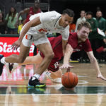 
              Miami's guard Isaiah Wong (2) and Rutgers' guard Cam Spencer (10) go after the ball during the first half of an NCAA college basketball game, Wednesday, Nov. 30, 2022, in Coral Gables, Fla. (AP Photo/Marta Lavandier)
            