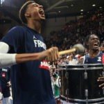 
              FILE - France's Victor Wembanyama, left, plays the drums after the FIBA Basketball World Cup 2023 European Qualifiers match between France and Bosnia Herzegovina in Pau, southwestern France, Monday, Nov. 14, 2022. Wembanyama's season for Metropolitans 92 in the French league keeps getting better. He's scored at least 30 points in his last two games, and his team has now won seven consecutive contests. That's helped them pull into a first-place tie with Cholet with a 7-1 record.(AP Photo/Bob Edme, File)
            