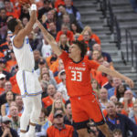
              UCLA guard Amari Bailey shoots over Illinois forward Coleman Hawkins (33) during the first half of an NCAA college basketball game Friday, Nov. 18, 2022, in Las Vegas. (AP Photo/Chase Stevens)
            