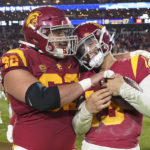 
              Southern California quarterback Caleb Williams, right, gets a hug from offensive lineman Brett Neilon after USC defeated Notre Dame 38-27 an NCAA college football game Saturday, Nov. 26, 2022, in Los Angeles. (AP Photo/Mark J. Terrill)
            