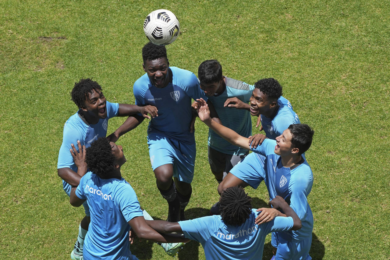 Youths play around at the end of training at the Independiente del Valle soccer club in Quito, Ecua...