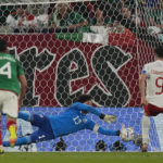 
              Mexico's goalkeeper Guillermo Ochoa saves a penalty kick by Poland's Robert Lewandowski during the World Cup group C soccer match between Mexico and Poland, at the Stadium 974 in Doha, Qatar, Tuesday, Nov. 22, 2022. (AP Photo/Themba Hadebe)
            