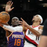 
              Portland Trail Blazers guard Josh Hart (11) shoots as Phoenix Suns center Bismack Biyombo (18) defends during the first half of an NBA basketball game, Saturday, Nov. 5, 2022, in Phoenix. (AP Photo/Matt York)
            