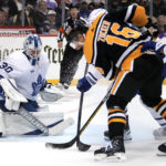
              Pittsburgh Penguins' Jason Zucker (16) can't gain control of the puck in front of Toronto Maple Leafs goaltender Matt Murray (30) during the second period of an NHL hockey game in Pittsburgh, Tuesday, Nov. 15, 2022. (AP Photo/Gene J. Puskar)
            