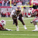 
              Minnesota running back Mohamed Ibrahim (24) runs between Wisconsin linebackers Darryl Peterson (17) and Maema Njongmeta, right, during the first half of an NCAA college football game Saturday, Nov. 26, 2022, in Madison, Wis. (AP Photo/Andy Manis)
            