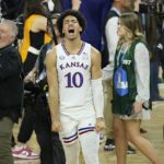 
              FILE - Kansas' Jalen Wilson (10) celebrates after a college basketball game against North Carolina in the finals of the Men's Final Four NCAA tournament on April 4, 2022, in New Orleans. Kansas will start off its season on Nov. 7, against Omaha. (AP Photo/Gerald Herbert, File)
            