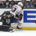 
              Los Angeles Kings center Rasmus Kupari, left, falls as he and Chicago Blackhawks center Colin Blackwell go after the puck during the second period of an NHL hockey game Thursday, Nov. 10, 2022, in Los Angeles. (AP Photo/Mark J. Terrill)
            