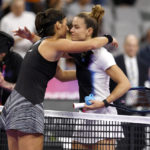 
              Caroline Garcia, left, of France, and Maria Sakkari, of Greece, embrace at the net following Garcia's win in two sets in the singles semifinals of the WTA Finals tennis tournament in Fort Worth, Texas, Sunday, Nov. 6, 2022. (AP Photo/Ron Jenkins)
            