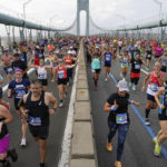 
              Runners cross the Verrazzano-Narrows Bridge at the start of the New York City Marathon in New York, Sunday, Nov. 6, 2022. (AP Photo/Seth Wenig)
            