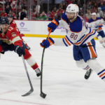 
              Edmonton Oilers defenseman Markus Niemelainen (80) passes the puck as Florida Panthers center Sam Reinhart (13) defends during the second period of an NHL hockey game, Saturday, Nov. 12, 2022, in Sunrise, Fla. (AP Photo/Lynne Sladky)
            