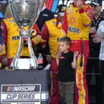 
              Joey Logano celebrates with his son Hudson after winning a NASCAR Cup Series auto race and championship Sunday, Nov. 6, 2022, in Avondale, Ariz. (AP Photo/Rick Scuteri)
            