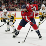 
              Washington Capitals center Nic Dowd, center, skates past Pittsburgh Penguins defenseman Kris Letang, back left, and right wing Bryan Rust in the second period of an NHL hockey game, Wednesday, Nov. 9, 2022, in Washington. (AP Photo/Patrick Semansky)
            