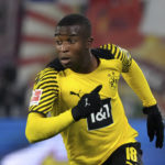 
              FILE -- Dortmund's Youssoufa Moukoko runs during the German Bundesliga soccer match between RB Leipzig and Borussia Dortmund in Leipzig, Germany, Saturday, Nov. 6, 2021. Germany is taking 17-year-old striker Youssoufa Moukoko to the World Cup, Coach Hansi Flick named his 26-man squad for Qatar on Thursday, rewarding Moukoko for scoring six goals and setting up four more in 13 Bundesliga appearances this season. (AP Photo/Michael Sohn, file)
            
