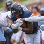 
              Virginia running back Mike Hollins (7) runs up the middle for a gain against North Carolina during the first half of an NCAA college football game on Saturday, Nov. 5, 2022, in Charlottesville, Va. (AP Photo/Mike Caudill)
            